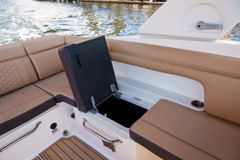  Yacht Photos Pics Luxury Sea Ray boat interior with open storage compartment and tan seating.