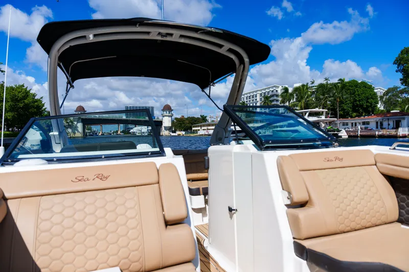  Yacht Photos Pics Luxury Sea Ray boat interior with tan seating, cruising on a sunny day.