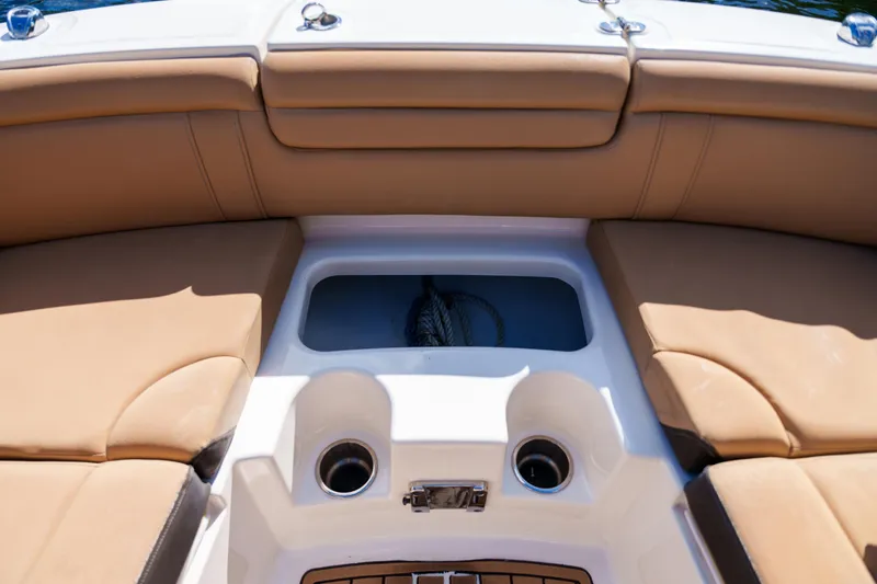 Yacht Photos Pics Interior view of a Sea Ray boat with tan seating and cup holders.