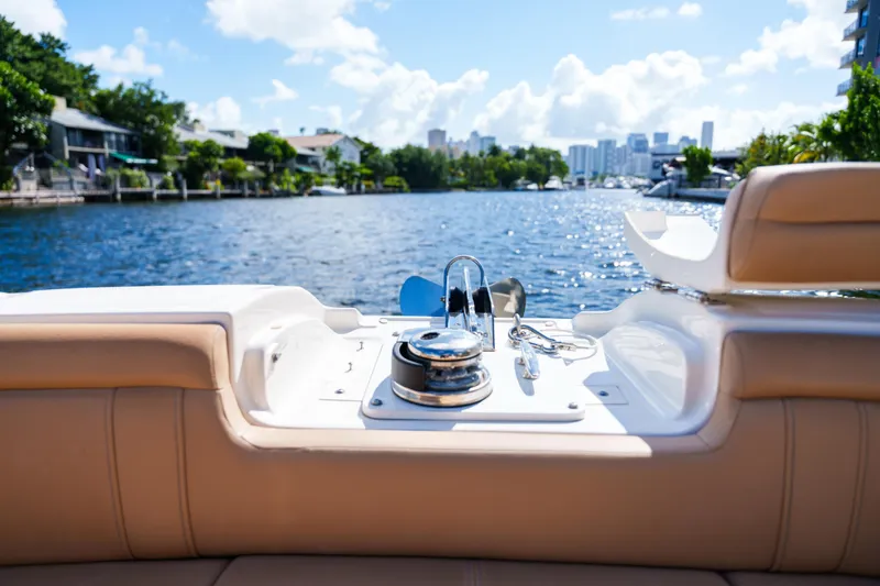  Yacht Photos Pics Luxury Sea Ray boat interior with waterfront view, featuring plush seating and sunny skies.