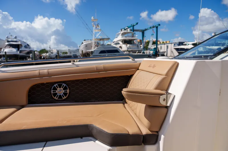  Yacht Photos Pics Luxurious Sea Ray boat interior with tan leather seating at a marina.