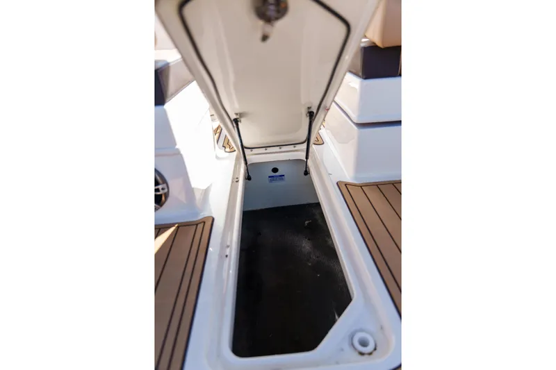  Yacht Photos Pics Open storage compartment on a Sea Ray boat with teak flooring.