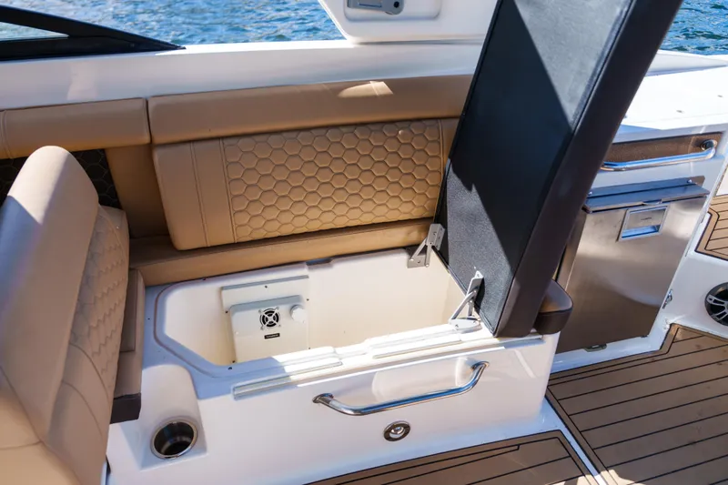  Yacht Photos Pics Luxurious Sea Ray boat interior with tan seating, storage compartment, and stainless steel accents.