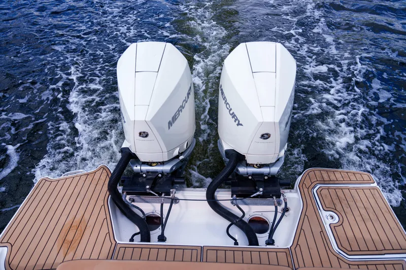  Yacht Photos Pics Twin Mercury outboard engines on a Sea Ray boat, cruising through water.