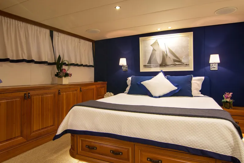 Parvati Yacht Photos Pics Luxurious bedroom interior on 1979 CRN Displacement yacht, featuring elegant wood cabinetry and nautical decor.