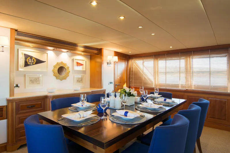Parvati Yacht Photos Pics Luxurious dining area on a 1979 CRN Displacement yacht with elegant decor and blue chairs.