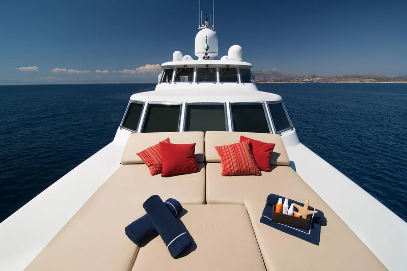 Parvati Yacht Photos Pics Luxurious 1979 CRN Displacement yacht deck with cushions and towels, cruising on open sea.