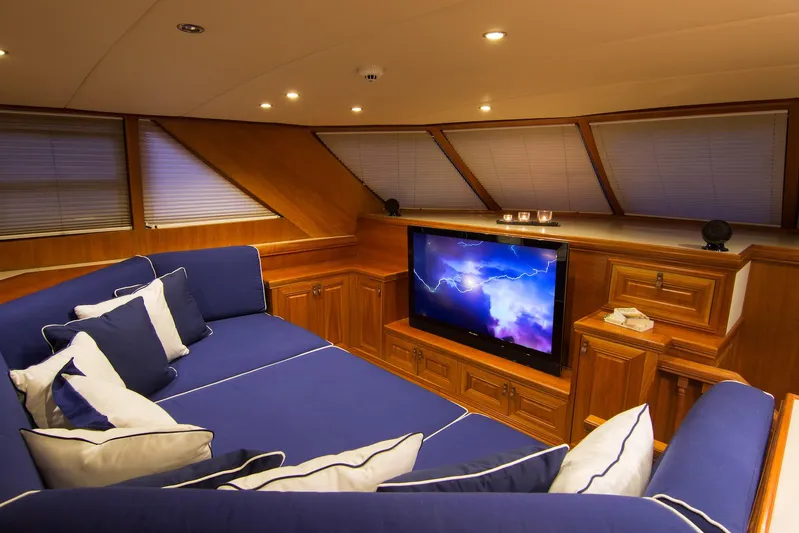 Parvati Yacht Photos Pics Luxurious 1979 CRN Displacement yacht interior with blue seating and a large TV.