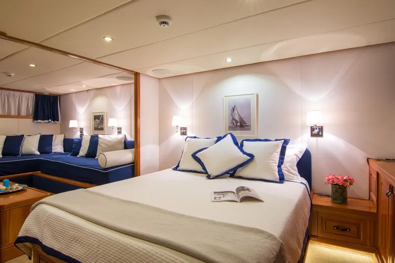 Parvati Yacht Photos Pics Luxurious 1979 CRN Displacement yacht bedroom with elegant decor and cozy seating area.