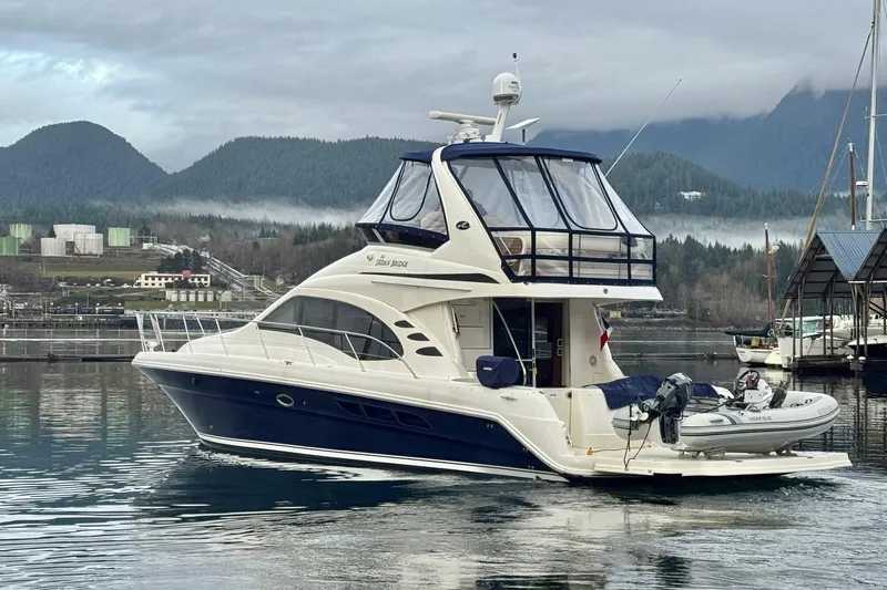 Covetime II Yacht Photos Pics 2006 Sea Ray 44 Sedan Bridge yacht docked in scenic marina with mountains.
