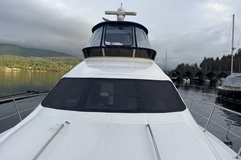 Covetime II Yacht Photos Pics 2006 Sea Ray 44 Sedan Bridge yacht docked in a serene marina setting.