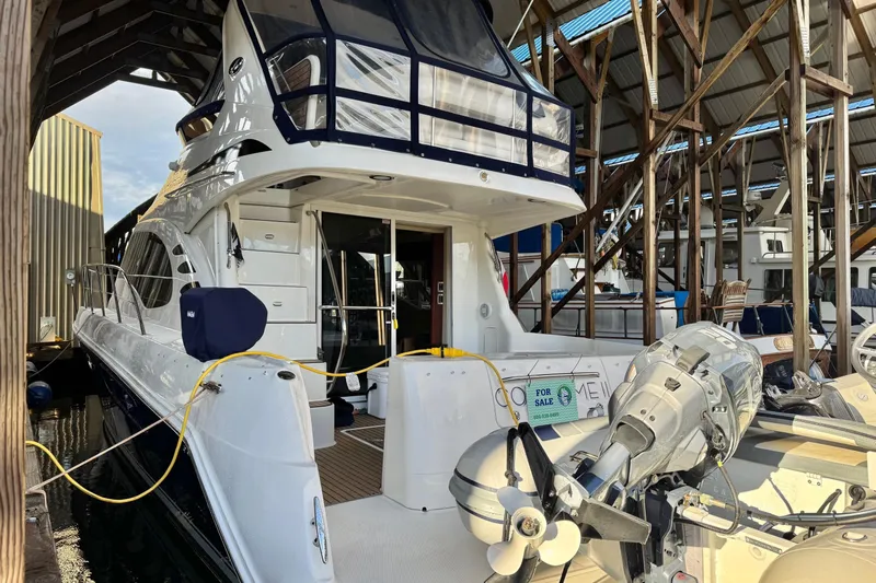 Covetime II Yacht Photos Pics 2006 Sea Ray 44 Sedan Bridge yacht docked in a marina, for sale sign visible.