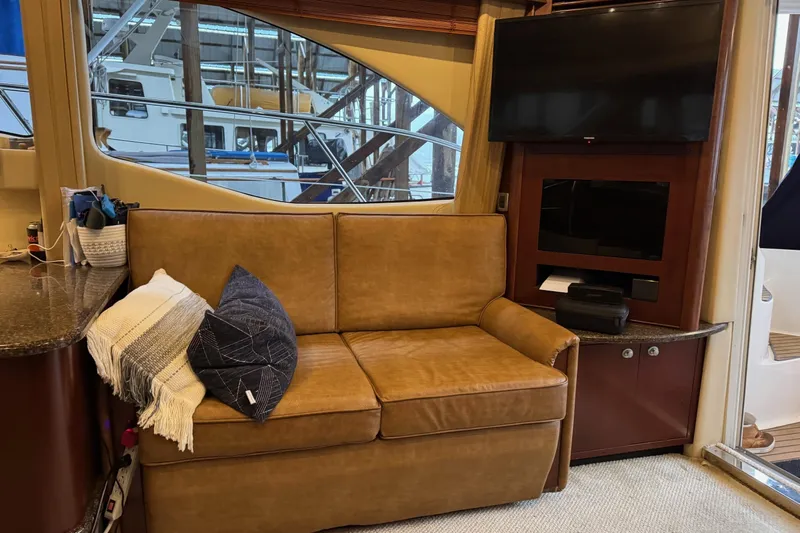 Covetime II Yacht Photos Pics Luxurious interior of 2006 Sea Ray 44 Sedan Bridge with leather sofa and TV.