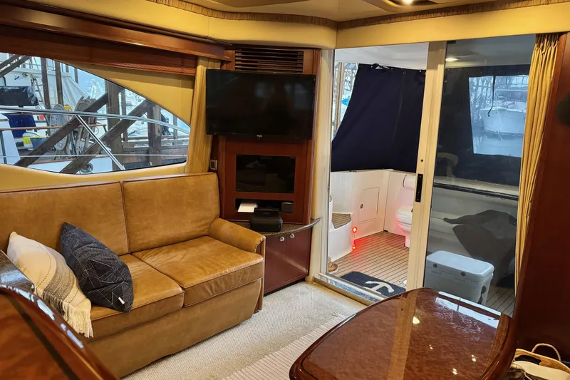 Covetime II Yacht Photos Pics Luxurious interior of 2006 Sea Ray 44 Sedan Bridge yacht with cozy seating and modern amenities.