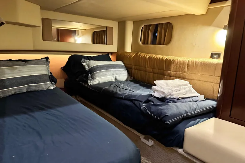 Covetime II Yacht Photos Pics Interior cabin of 2006 Sea Ray 44 Sedan Bridge with twin beds and cozy decor.