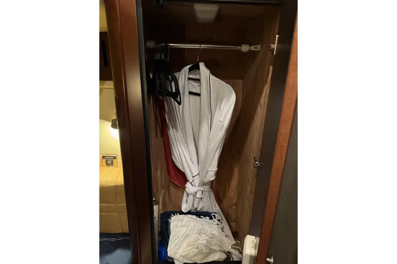 Covetime II Yacht Photos Pics Closet interior on 2006 Sea Ray 44 Sedan Bridge with robe and hangers.