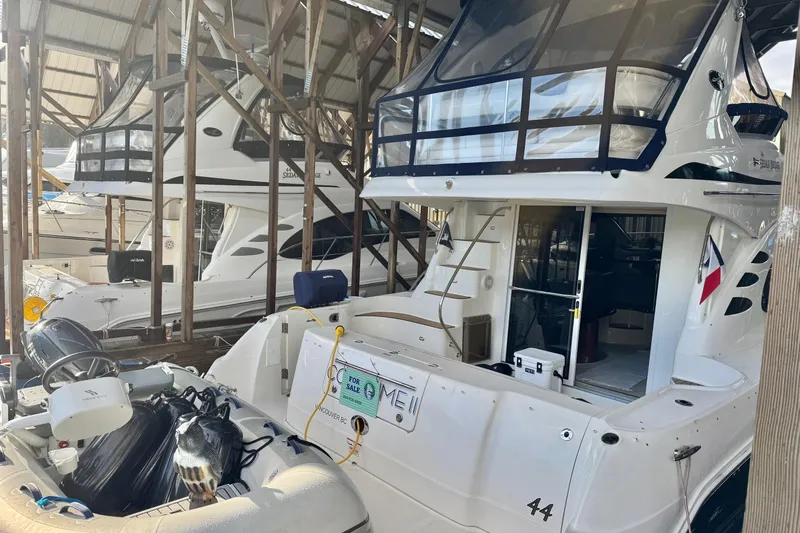 Covetime II Yacht Photos Pics 2006 Sea Ray 44 Sedan Bridge yacht docked in a marina, rear view.