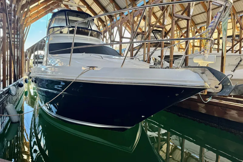 Covetime II Yacht Photos Pics 2006 Sea Ray 44 Sedan Bridge yacht docked in a covered marina.
