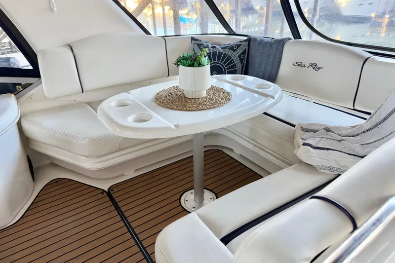 Covetime II Yacht Photos Pics Luxurious interior of 2006 Sea Ray 44 Sedan Bridge with elegant seating and table.