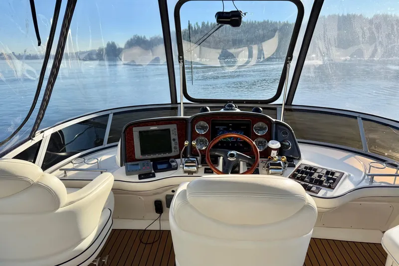 Covetime II Yacht Photos Pics 2006 Sea Ray 44 Sedan Bridge helm with scenic water view.