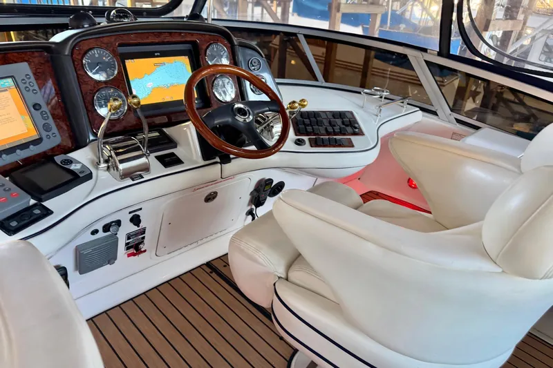 Covetime II Yacht Photos Pics Helm of 2006 Sea Ray 44 Sedan Bridge with navigation equipment and luxurious seating.