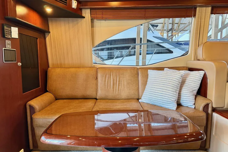 Covetime II Yacht Photos Pics Luxurious interior of 2006 Sea Ray 44 Sedan Bridge with leather sofa and cushions.
