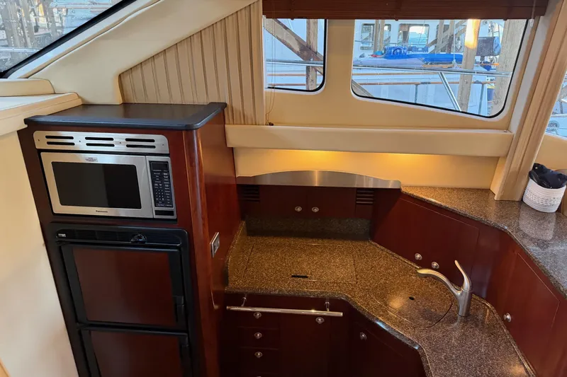 Covetime II Yacht Photos Pics Luxurious 2006 Sea Ray 44 Sedan Bridge yacht kitchen with modern appliances and elegant design.