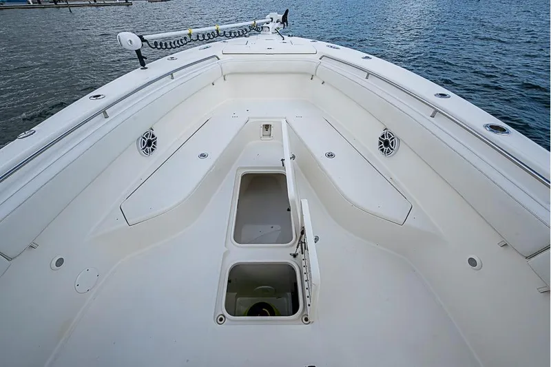  Yacht Photos Pics 2007 Triton 351 CC boat deck with open storage compartments, docked by the water.