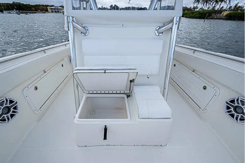  Yacht Photos Pics 2007 Triton 351 CC boat interior with open storage compartment, white seating, and water view.