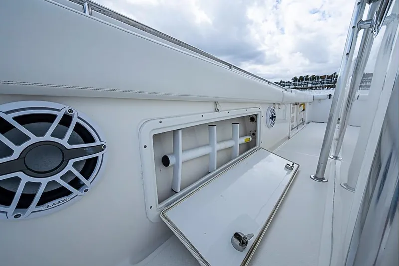  Yacht Photos Pics 2007 Triton 351 CC boat deck with storage compartment and audio speaker.