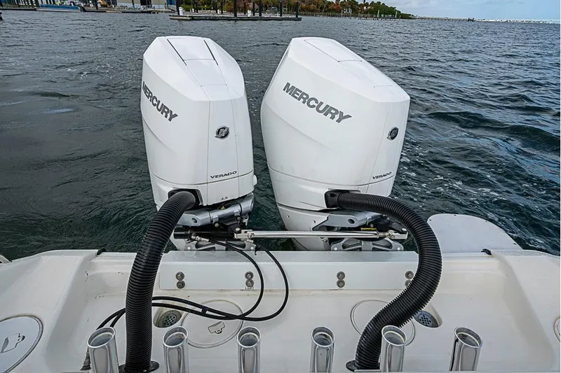  Yacht Photos Pics Twin Mercury Verado engines on a 2007 Triton 351 CC boat, docked on a calm sea.