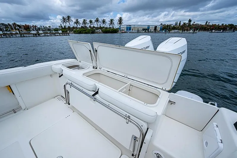  Yacht Photos Pics 2007 Triton 351 CC boat with open storage compartments on a calm water backdrop.