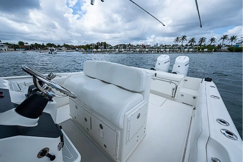  Yacht Photos Pics 2007 Triton 351 CC boat interior with white seating, steering wheel, and dual Mercury engines.