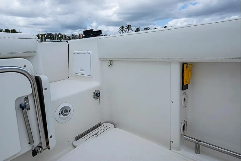  Yacht Photos Pics 2007 Triton 351 CC boat interior with white seating and storage compartments.