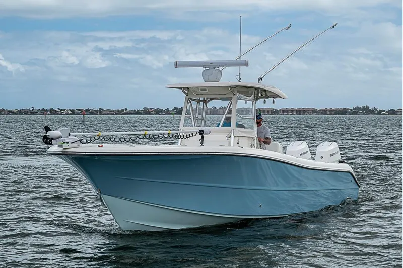  Yacht Photos Pics 2007 Triton 351 CC boat cruising on open water under a cloudy sky.