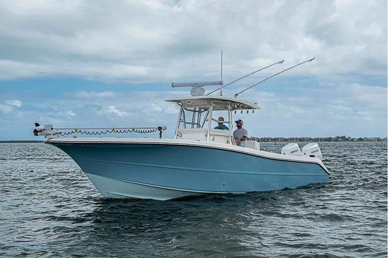  Yacht Photos Pics 2007 Triton 351 CC boat on water, featuring blue hull and twin engines.