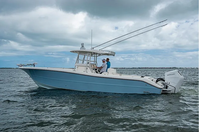  Yacht Photos Pics 2007 Triton 351 CC boat on water with two people.