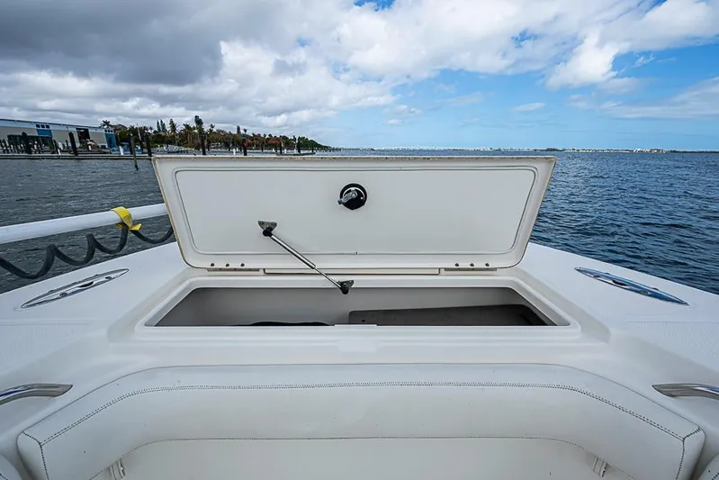  Yacht Photos Pics Open storage compartment on 2007 Triton 351 CC boat, with ocean and cloudy sky background.