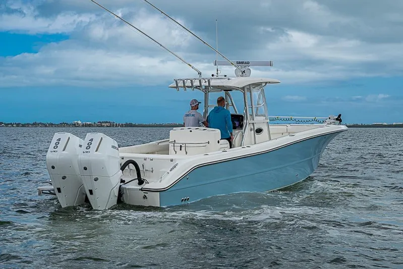  Yacht Photos Pics 2007 Triton 351 CC boat cruising on open water with twin Mercury engines.