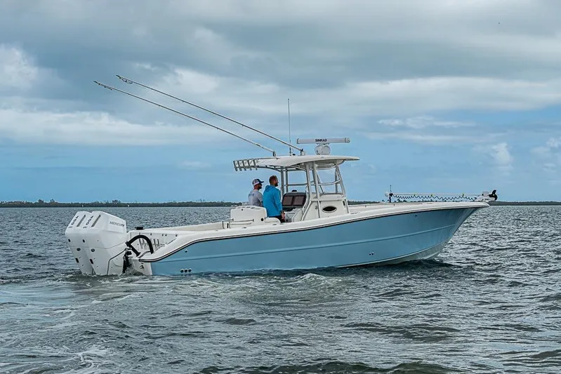  Yacht Photos Pics 2007 Triton 351 CC boat cruising on open water under cloudy skies.