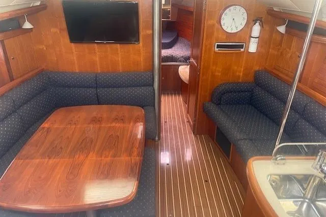 The Boat Yacht Photos Pics Interior of 2007 Marlow-Hunter 45CC yacht with wood finish and seating area.