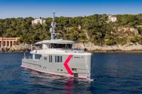 Custom 2024 K584 Hull 2 yacht cruising near a scenic coastline.