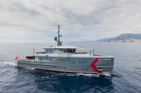 Custom 2024 K584 Hull 2 yacht cruising on open sea with coastal backdrop.