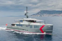 Custom K584 Hull 2 yacht cruising on the ocean, 2024 model, with coastal city backdrop.