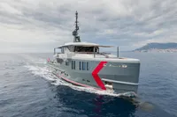 2024 Custom K584 Hull 2 yacht cruising on open sea under cloudy skies.