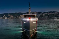 Front view of Custom K584 Hull 2 yacht, 2024 model, illuminated on calm waters at dusk.