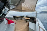 Luxurious 2024 Custom K584 Hull 2 yacht deck with seating, tables, and ocean view.