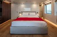 Luxurious bedroom on Custom K584 Hull 2 yacht, 2024 model, with modern decor and ocean view.