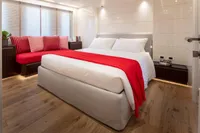 Luxurious bedroom in 2024 Custom K584 Hull 2 yacht with modern decor and red accents.