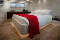 Luxurious bedroom with modern design, featuring a red blanket on a sleek bed, 2024 Custom K584 Hull 2.